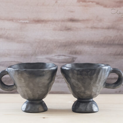 Black pottery mugs