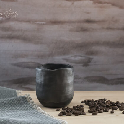 Handmade black pottery coffee mug without handle