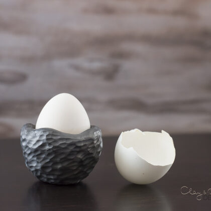 textured black pottery egg holder