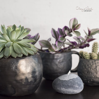 Handmade black pottery pot for plants.