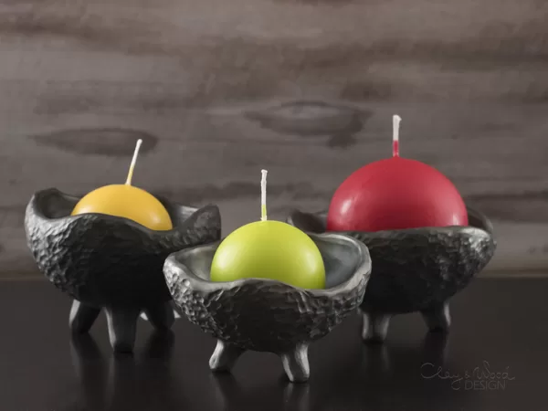 Black ceramic bowl on legs. Candle holder. Pinch pot.