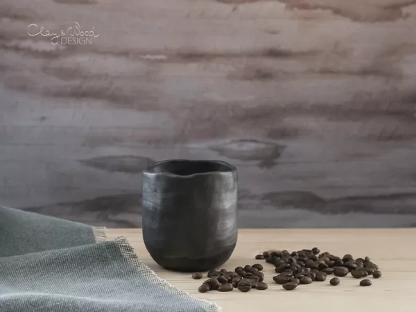 Handmade black pottery coffee mug without handle