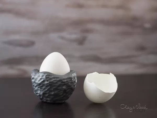 textured black pottery egg holder