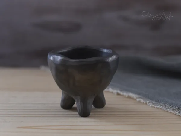 black pottery egg holder