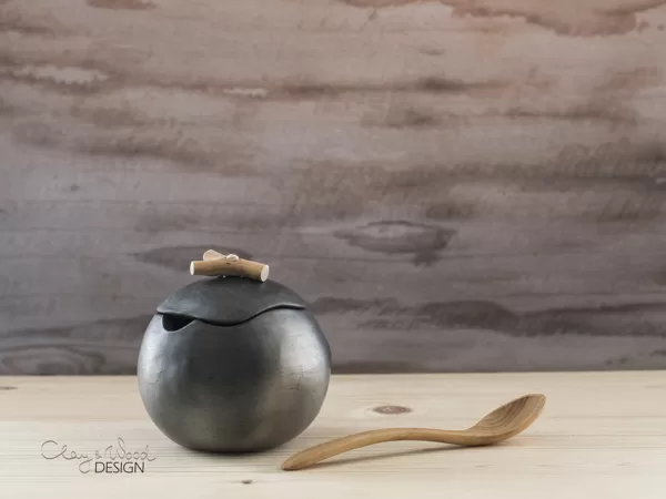 Handmade black ceramic pot for sugar with place for spoon