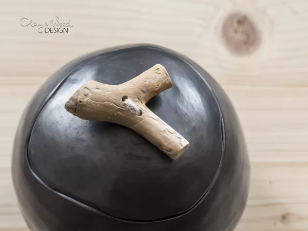 Handmade black ceramic cellar with lid and wooden handle