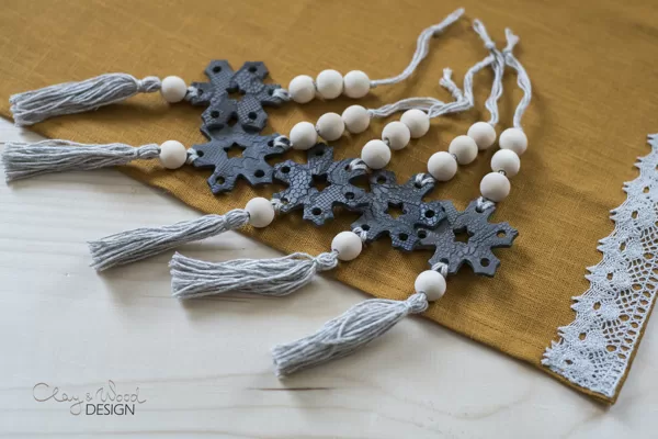 Christmas tree ornaments. Handmade pottery decors in shape of snowflake.