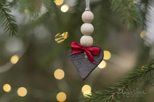 Black ceramic heart with wooden beads and red ribbon. Christmas tree decors.
