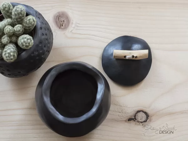 Small handmade black ceramic cellar with cover