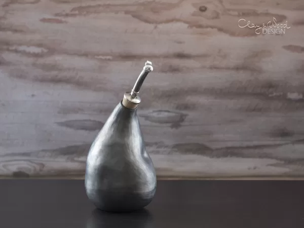 Handmade black ceramic oil bottle.